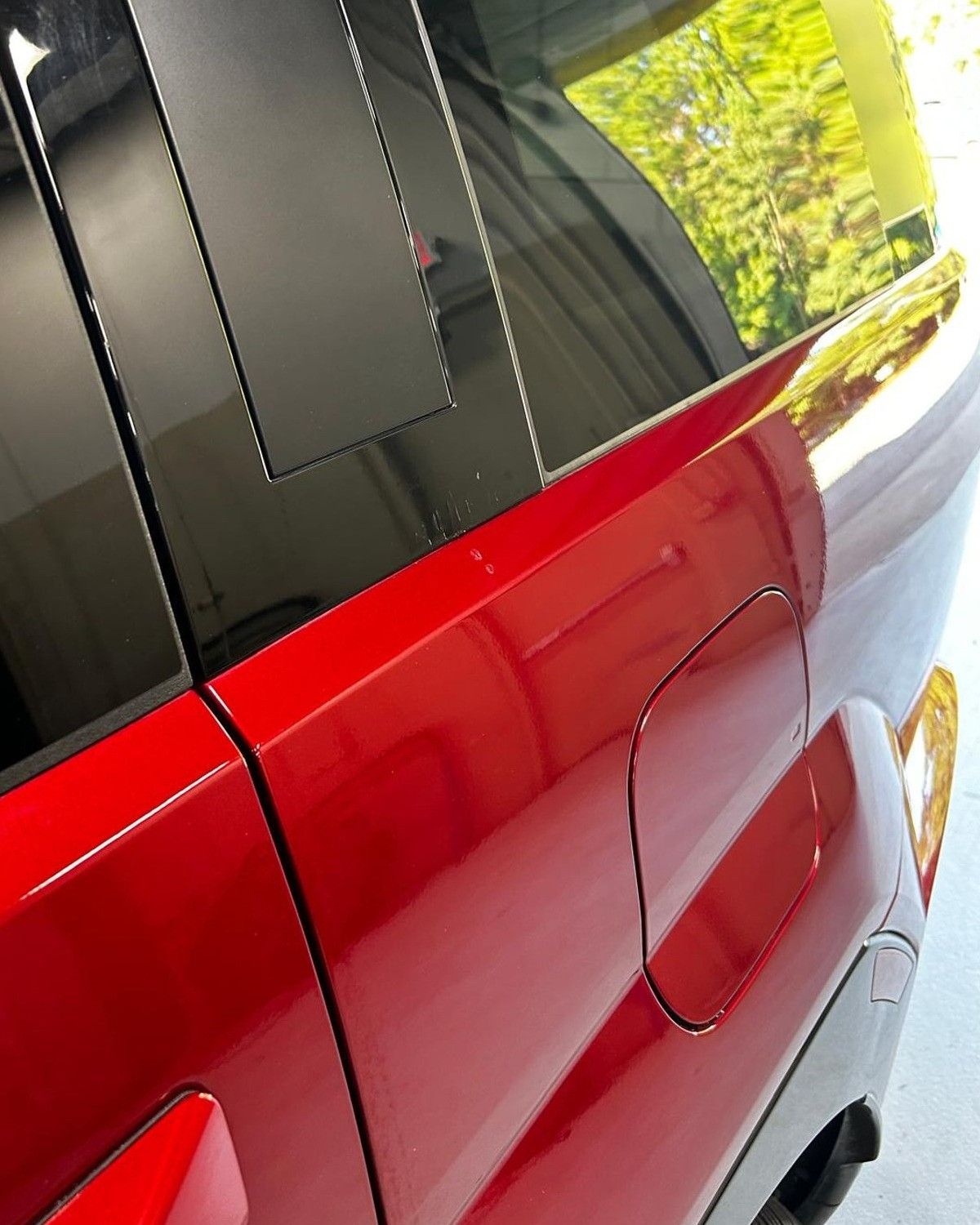 After: the same red quarter panel with a smooth, dent-free surface